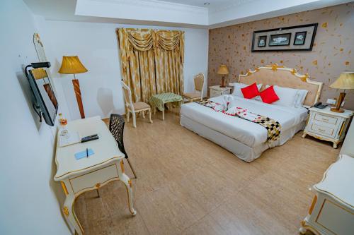 a hotel room with a large bed and a desk at Hotel Sidhartha Chalakudy in Kizhake Chālakudi