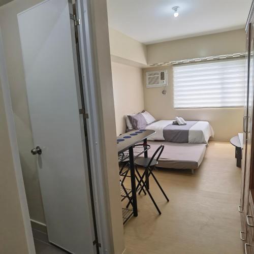 a hospital room with a bed and a table at Avida Davao by davaobnb & Lemonique Homes in Davao City