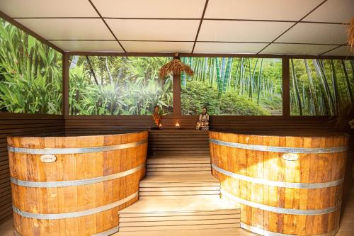 a bar in a forest with wooden logs at Mantar Spa Hotel in Marikostinovo