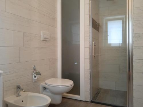 a bathroom with a toilet and a shower and a sink at Villa don peppe in Selva di Fasano
