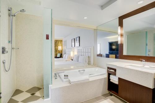 a bathroom with a bath tub and a sink at Hyatt Regency Guam in Tumon