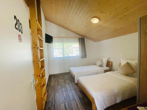 a room with two beds and a ladder in it at Swiss Chalet Holidays Ringgenberg in Ringgenberg