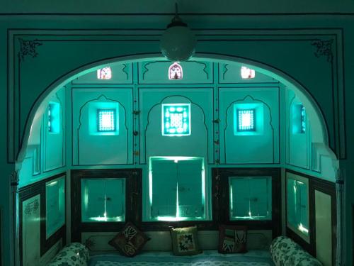 an arched room with blue lighting in a house at Jaipur Haveli in Jaipur