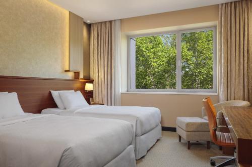 En eller flere senge i et værelse på Four Points by Sheraton Kecskemét Hotel és Konferenciaközpont