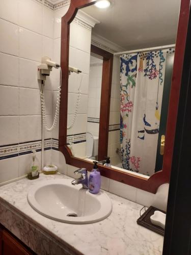 a bathroom with a sink and a mirror at Casa Beatriz in Cala San Vicente