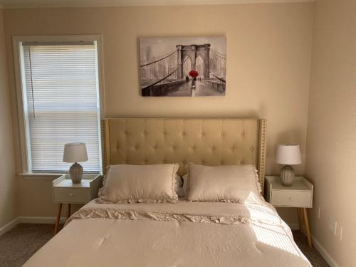 a bedroom with a bed with a painting on the wall at __Kristian’s Palace Your Beach Getaway in Kill Devil Hills