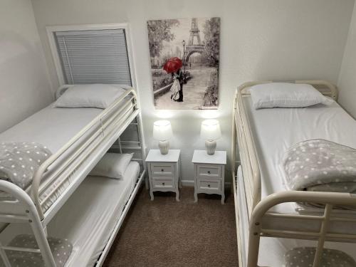 a room with two bunk beds and a woman with a red umbrella at __Kristian’s Palace Your Beach Getaway in Kill Devil Hills