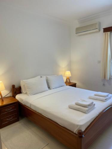 a bedroom with a bed with two towels on it at Beach House With Direct Access to Private Beach Near Bodrum in Çamlık