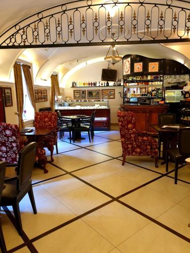 a restaurant with tables and chairs and a bar at Arbia Dorka Heritage Palace in Varaždin