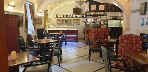 a restaurant with tables and chairs and a bar at Arbia Dorka Heritage Palace in Varaždin