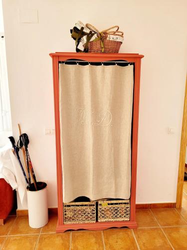 a wooden stand with a curtain on the floor at Luminoso con vistas y chimenea apto mascotas in Benaocaz