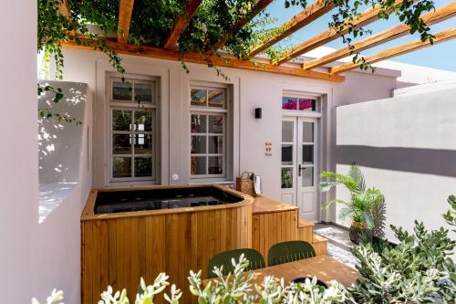 a patio with a hot tub in a house at Marillia Village in Perivolos
