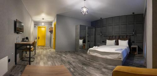 a bedroom with a large bed and a desk at Gudauri Loft Hotel in Gudauri