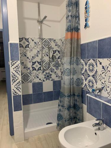 a bathroom with a shower and a sink at Casa di nonna Marianna in Baunei
