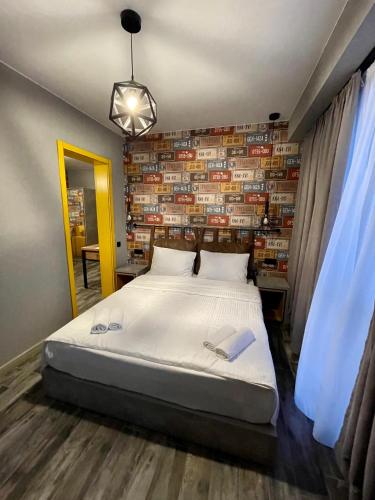 a bedroom with a bed and a wall of books at Gudauri Loft Hotel in Gudauri