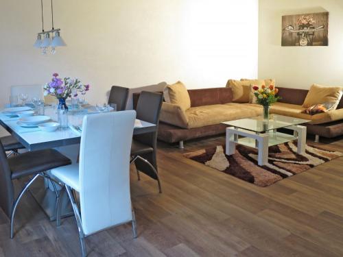 a living room with a table and a couch at Apartment Ingrid - FUC170 by Interhome in Fusch an der Glocknerstraße