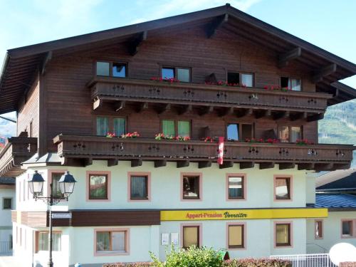 a building with a balcony with flowers on it at Apartment Vorreiter-1 by Interhome in Uttendorf