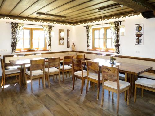 a dining room with wooden tables and chairs at Chalet Aualm - FRT100 by Interhome in Forstau