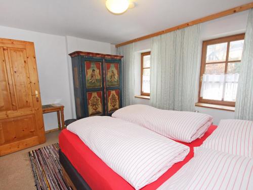 two beds in a room with two windows at Chalet Dr-Steiner by Interhome in Zell am See