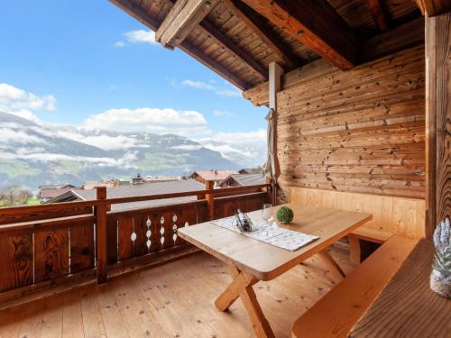 a wooden balcony with a wooden table on a wooden deck at Apartment Apart Wurm - SUZ380 by Interhome in Stummerberg