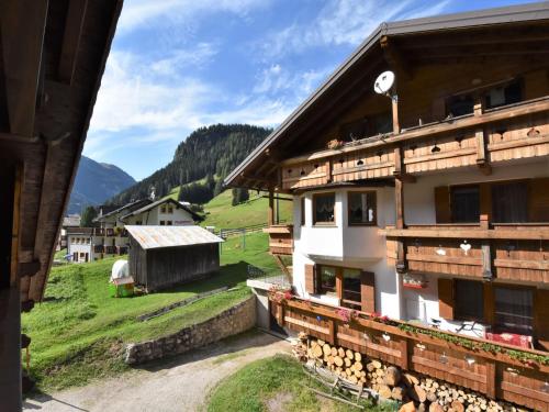 a view of a building with a mountain in the background at Chalet Cesa Galadriel-1 by Interhome in Penia