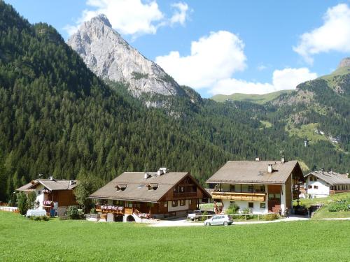 a group of buildings in front of a mountain at Chalet Cesa Galadriel-1 by Interhome in Penia
