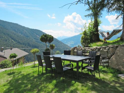 a table and chairs with a view of a mountain at Chalet Alm Chalet by Interhome in Gattererberg