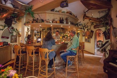 a man and a woman sitting at a bar at Landhotel Grimmeblick in Winterberg