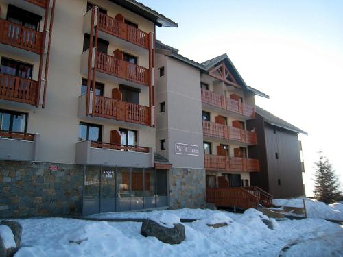 a apartment building with snow in front of it at Apartment Val d'Huez by Interhome in L'Alpe-d'Huez