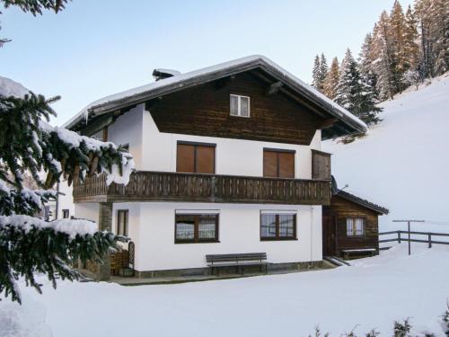a house in the snow with a bench in front at Holiday Home Thaler by Interhome in Obernberg am Brenner