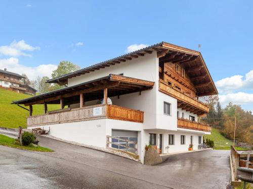 a large white building with a wooden roof at Apartment Apart Wurm-2 by Interhome in Stummerberg