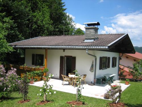 a small white house with a roof at Chalet Amberg by Interhome in Schwoich