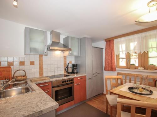 a kitchen with a sink and a stove top oven at Apartment Beim Holzschnitzer-1 by Interhome in Sölden