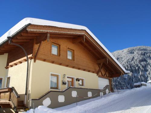 a building with snow on the ground in front of it at Holiday Home Reichegger by Interhome in Grün