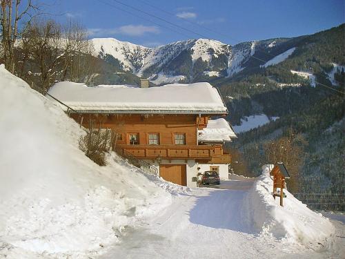 a snow covered house on a snow covered mountain at Apartment Unterpirchhof by Interhome in Thumersbach