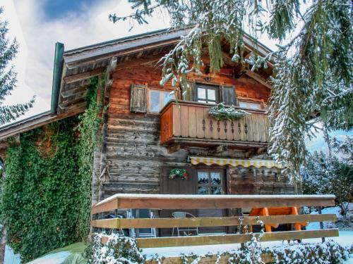 a log cabin with a porch and a balcony at Chalet Waldner by Interhome in Thannrain