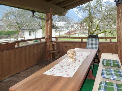 - une table et des chaises en bois sur une terrasse couverte dans l'établissement Apartment Anger - MHO163 by Interhome, à Mayrhofen