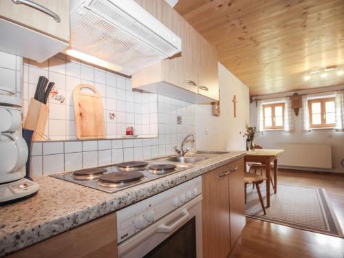 a kitchen with a stove and a sink at Apartment Beim Holzschnitzer-4 by Interhome in Sölden