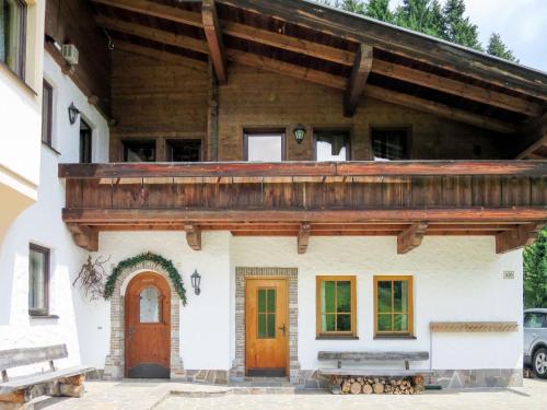 a house with a wooden roof and two doors at Holiday Home Berghaus - MHO764 by Interhome in Hippach