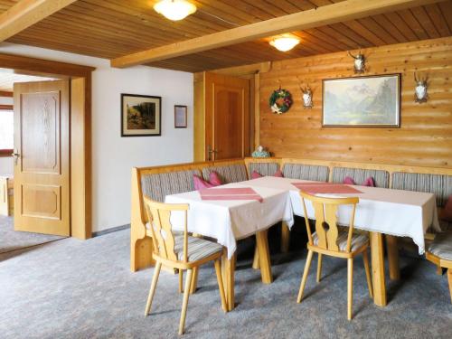 a dining room with a white table and chairs at Holiday Home Baggenhof by Interhome in Laimach