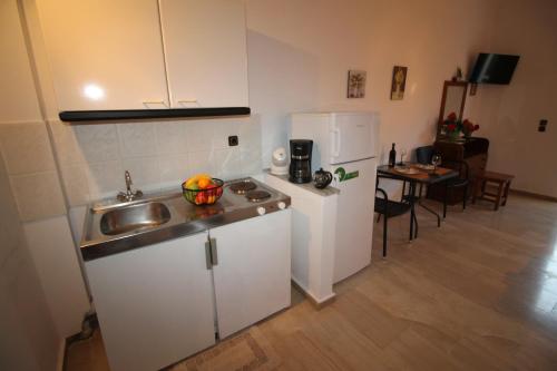 a small kitchen with a sink and a refrigerator at Panorama in Agios Georgios