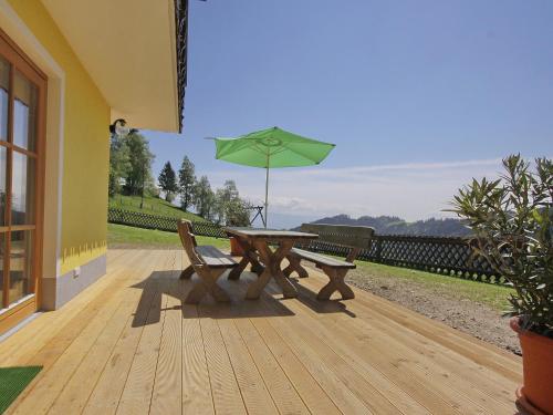 a wooden deck with a picnic table and an umbrella at Holiday Home Schönhart by Interhome in Lippbauer