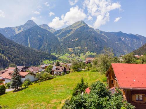 a village in a valley with mountains in the background at Apartment Helmreich-1 by Interhome in Sankt Gallenkirch