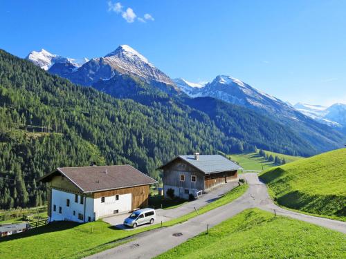 an aerial view of two buildings and a road with mountains at Apartment Oberkofl - LNH300 by Interhome in Tux