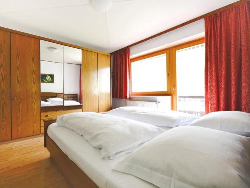 a bedroom with two beds and a large window at Holiday Home Ferienhaus Haus Kofler by Interhome in Radenthein
