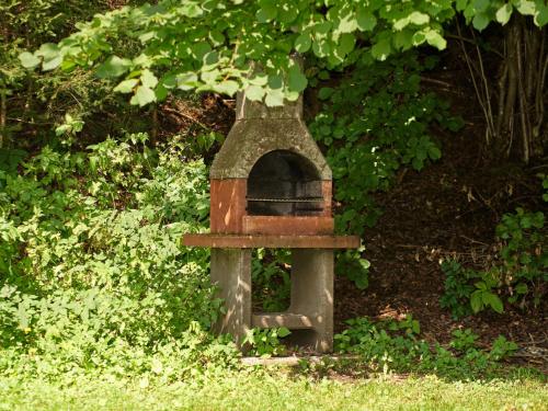 a bird house sitting in the grass under a tree at Chalet Neunhoeffer by Interhome in Patergassen