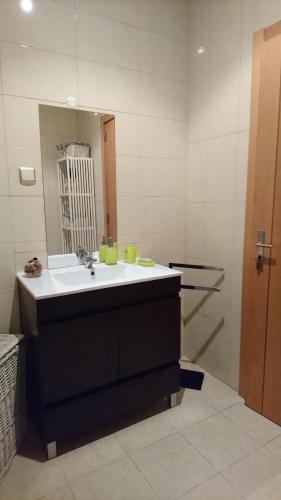 a bathroom with a sink and a mirror at Faro City Center Apartment I in Faro
