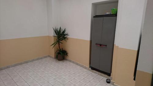 a room with a cabinet and a potted plant at Faro City Center Apartment I in Faro