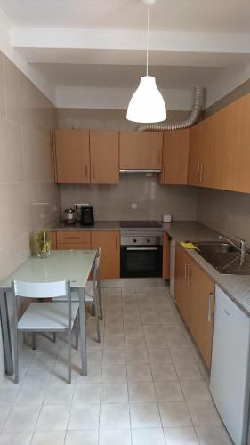 a kitchen with a table and a table and a sink at Faro City Center Apartment I in Faro