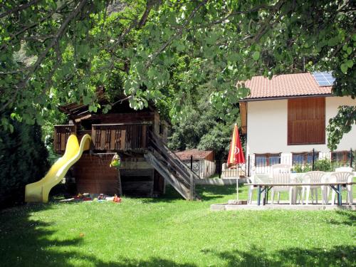 a playground with a slide in a yard at Holiday Home Aster by Interhome in Tösens